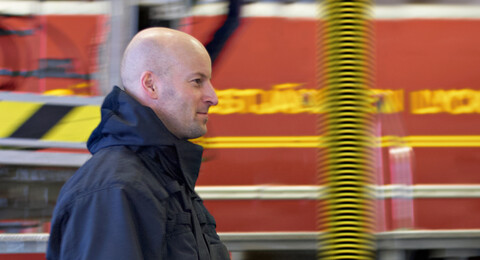 marshfield_fire_department_teaser-fire-fighter-walking-in-front-of-fire-truck-and-exhaust-extraction-hose