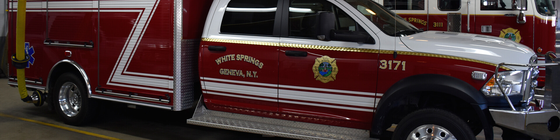 white_springs_fire_department_hero-banner-fire-truck-with-exhaust-extraction-hose-along-with-magnetic-grabber-and-safety-disconnect-handle
