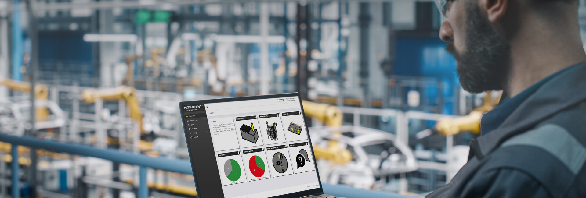 Engineer looking at a laptop in a factory