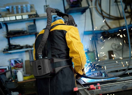 Welder with respiratory protective equipment