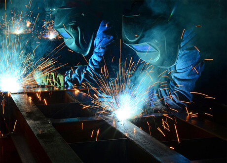 Two welders with smoke production